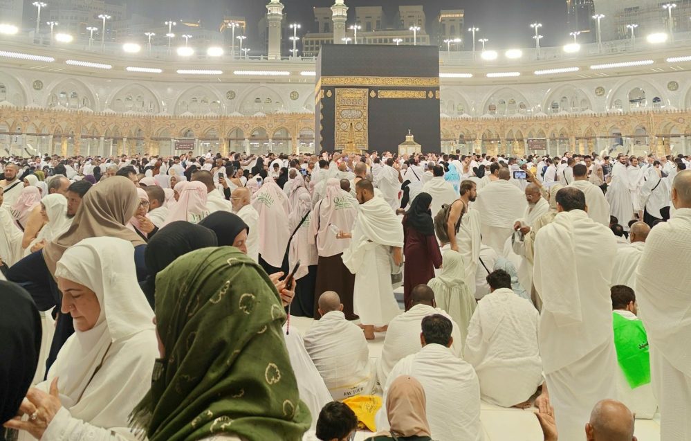 A crowded scene of pilgrims gathering at the Kaaba, Mecca during the night.