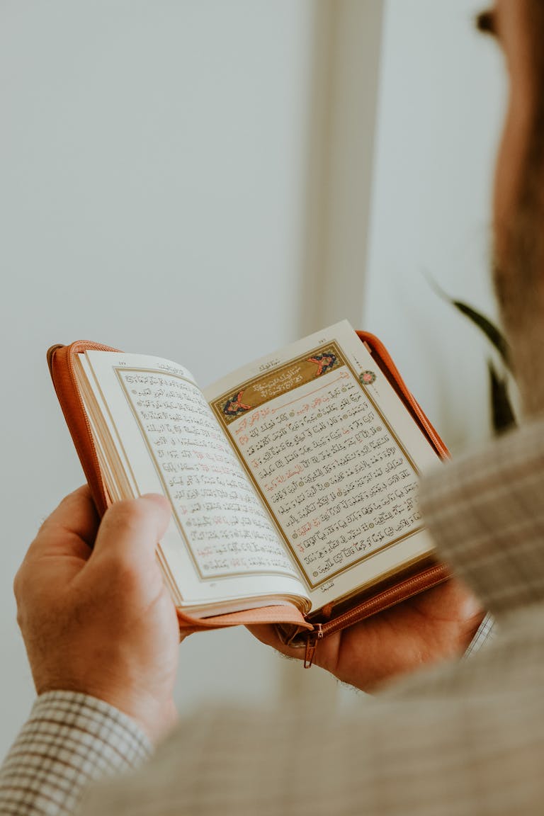Back View of Man Reading Koran