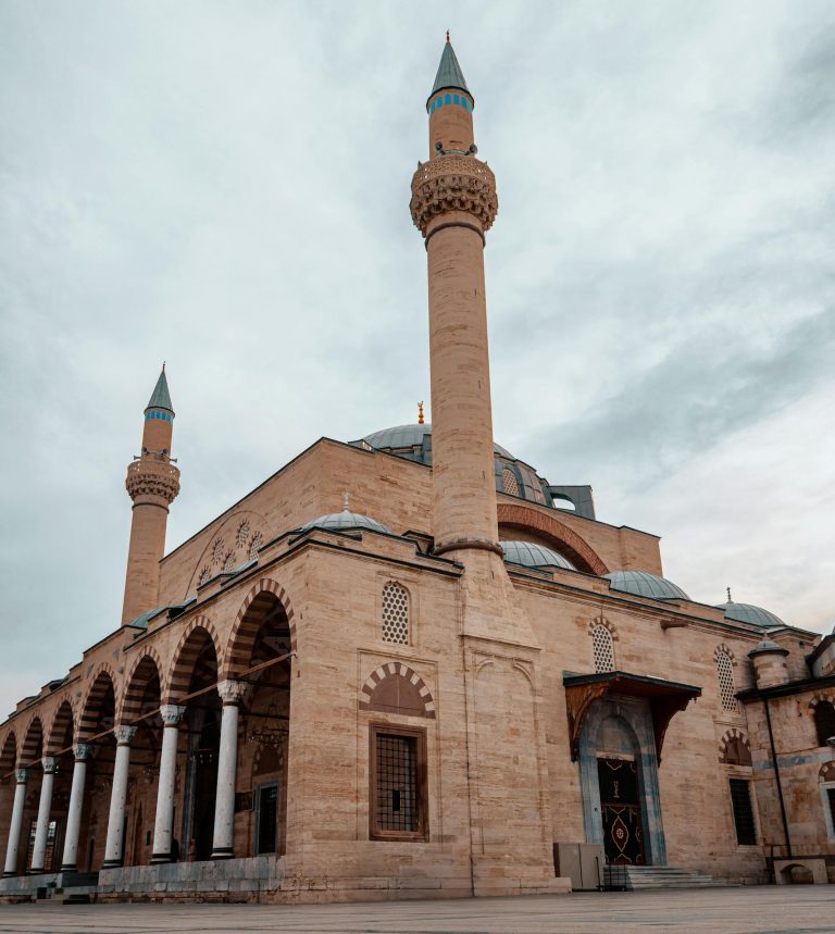 Dramatic view of Mevlana Museum mosque with cloudy sky in Konya, Turkey.
