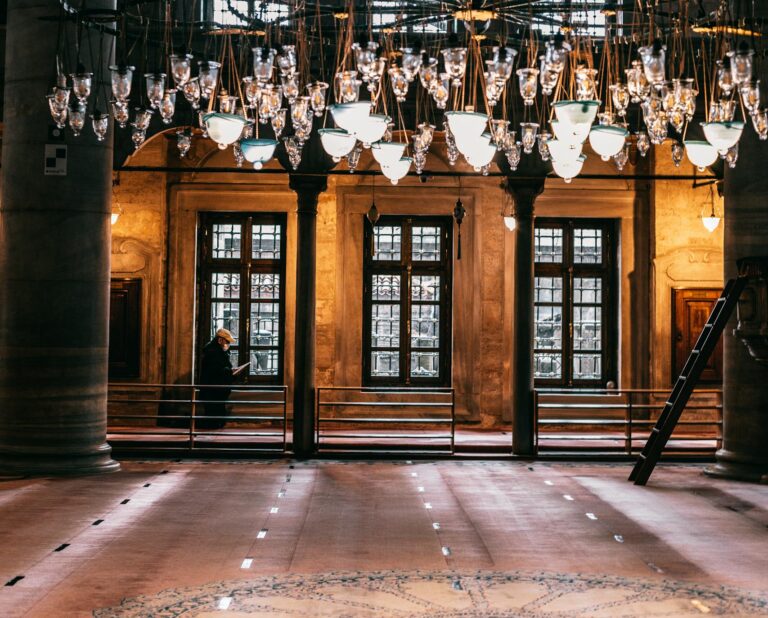 Elegant chandelier inside an Ottoman-style mosque in Istanbul, showcasing Islamic architecture.